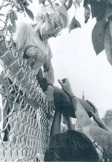 Frances climbs the Seneca Falls Army Depot fence to oppose Cruise missiles in 1983